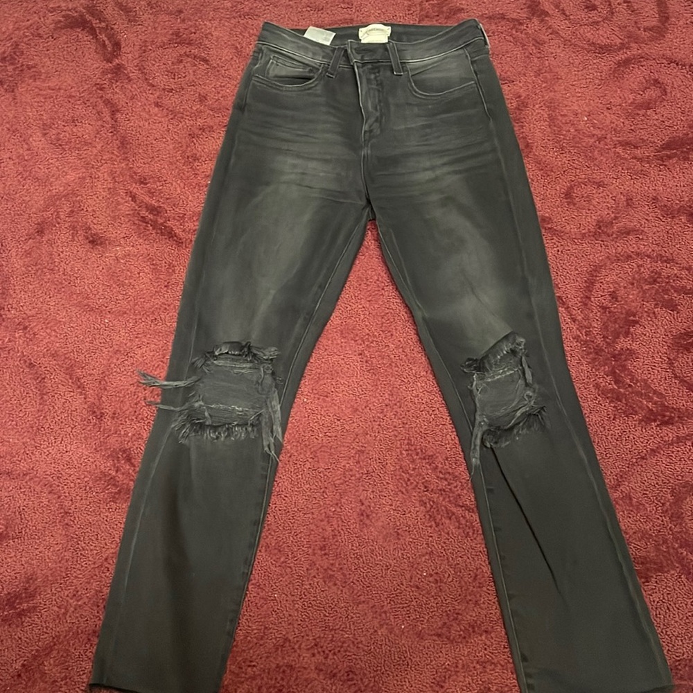 Black straight L’AGENCE jeans with ripped by the knee area